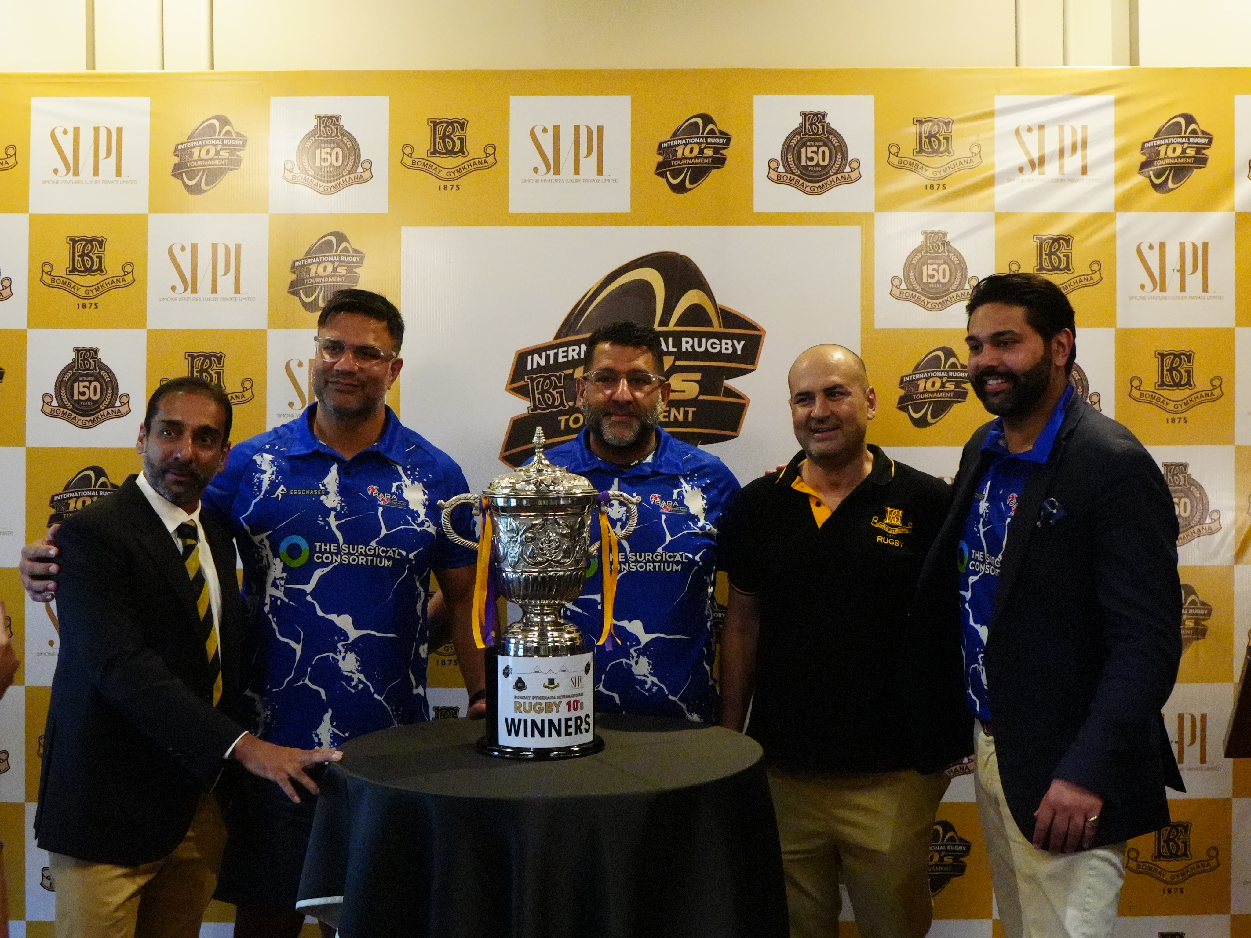 Jagmohan Johal, Mick Johal and Gurjinderpal Singh Pahal alongside Bombay Gymkhana officials with the Mumbai International Rugby 10s trophy won with BARA.
